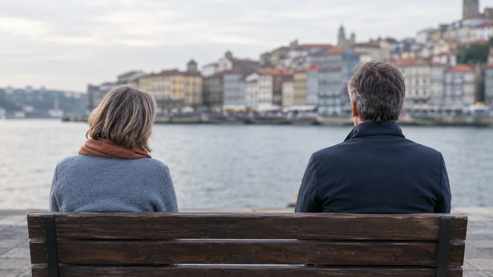 Casal de costas sentado num banco junto ao Douro, em Vila Nova de Gaia, com um espaço vazio entre os dois, tema do afastamento no casal, Dra. Gizela Silva, psicologia em Vila Nova de Gaia.